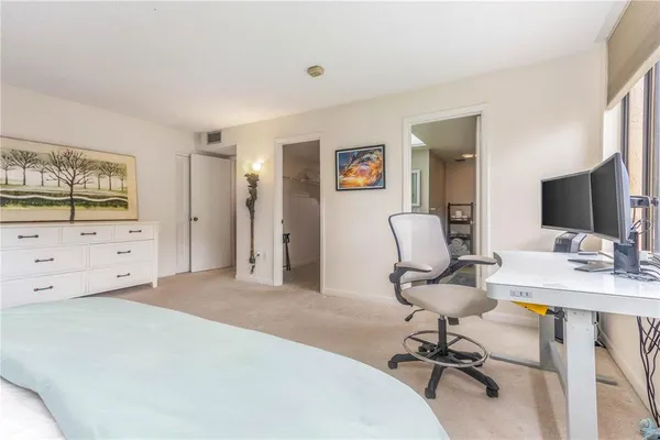a bathroom with a granite countertop shower and a sink