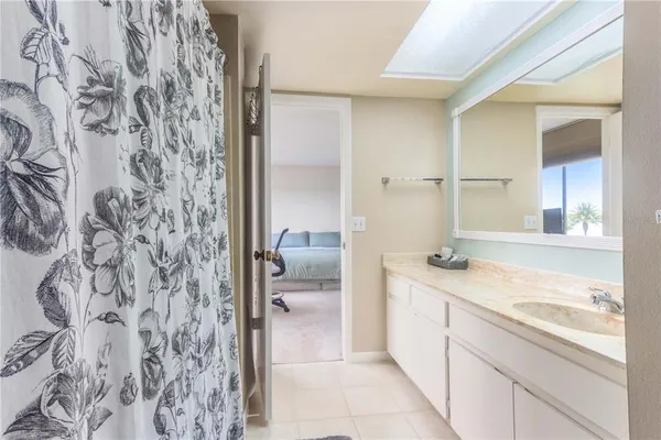a bathroom with a toilet mirror and vanity