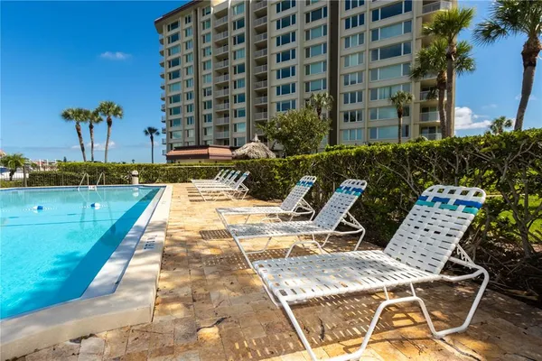 a view of swimming pool with outdoor seating and plants