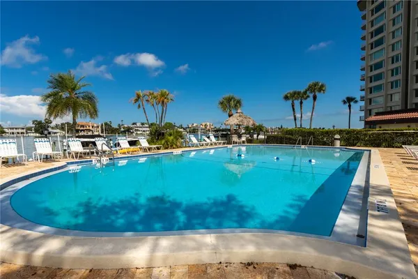 a view of a lake with lawn chairs