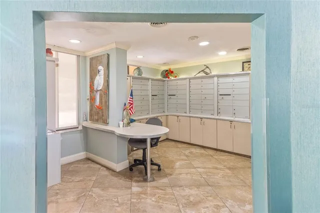 a view of a patio with table and chairs under an umbrella with a lake view