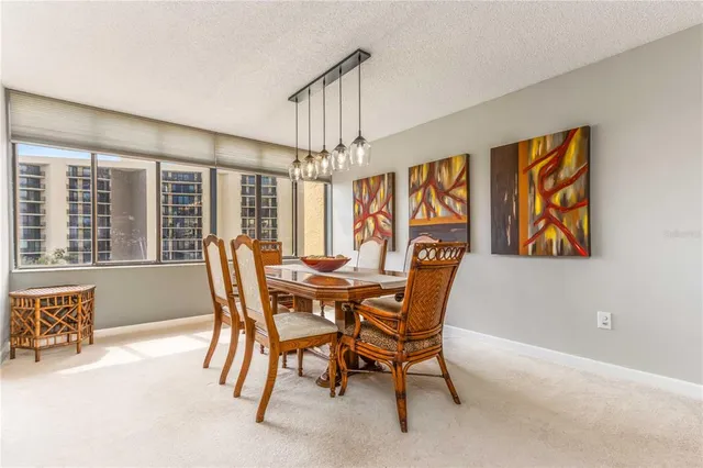 a dining room with furniture a chandelier and wooden floor