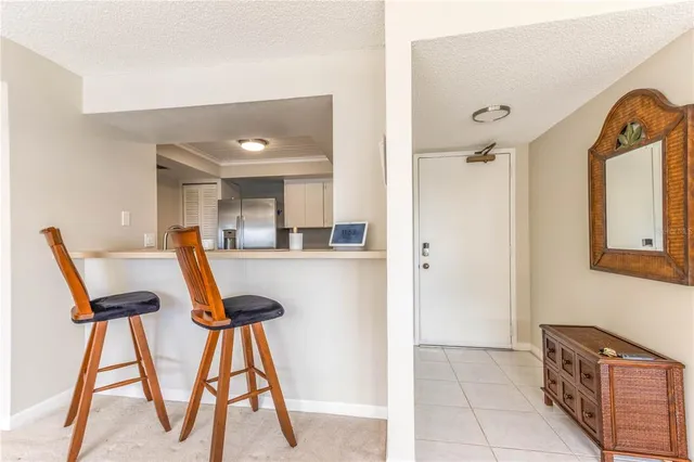 a view of a hallway with wooden floor and a livingroom view