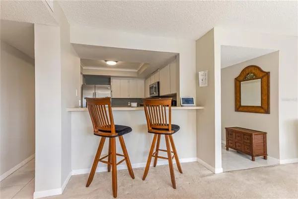 a dining room with furniture a chandelier and a rug