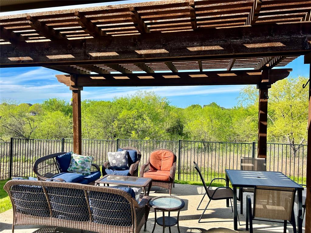 16117 Harper Road Prosper, TX 75078 - Photo 6 of 8 a view of a balcony with chairs and wooden floor
