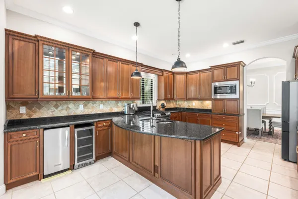 a kitchen with center island a sink cabinets and stainless steel appliances