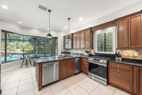 a kitchen with stainless steel appliances granite countertop counter space a sink and cabinets