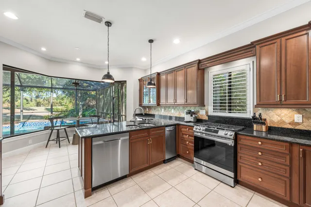 a kitchen with stainless steel appliances granite countertop counter space a sink and cabinets