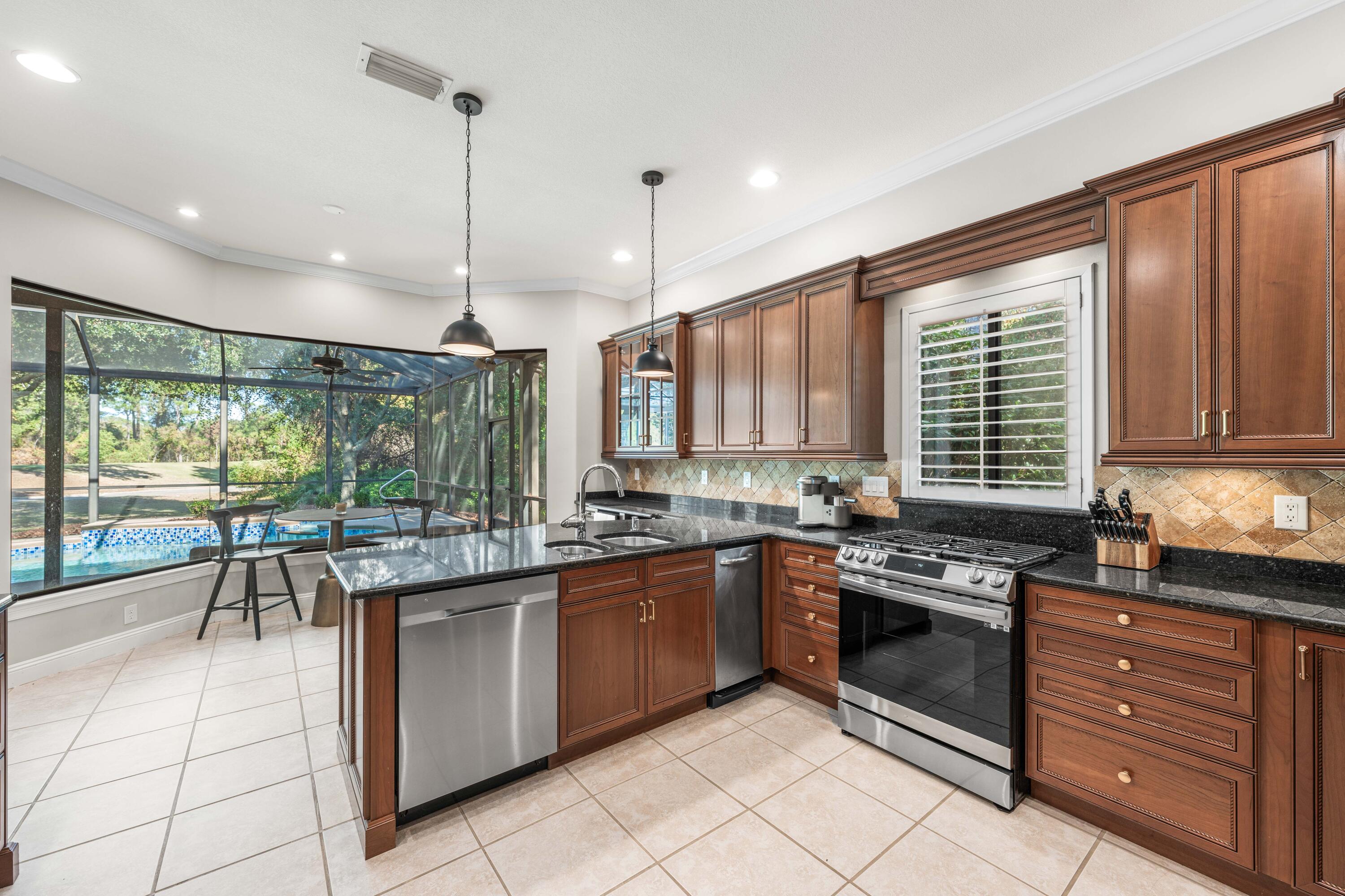 4345 Carriage Lane Destin, FL 32541 - Photo 15 of 39 a kitchen with stainless steel appliances granite countertop counter space a sink and cabinets