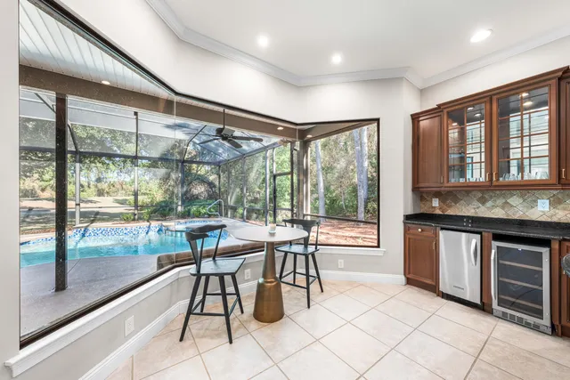 a dining hall with stainless steel appliances granite countertop a stove top oven a sink with granite countertops and cabinets