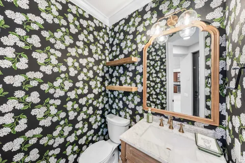 a bathroom with a sink a toilet and shower curtain