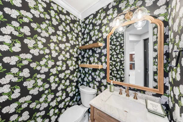 a bathroom with a sink a toilet and shower curtain