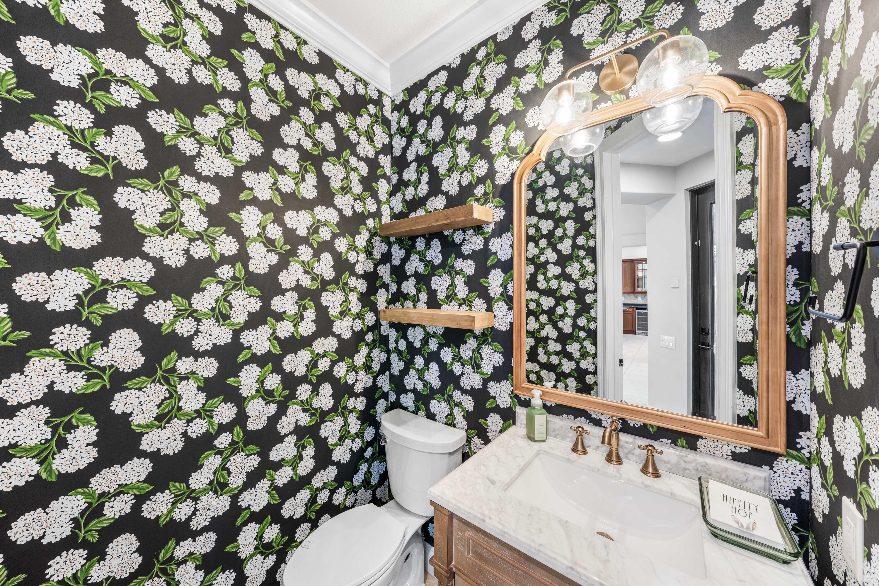 4345 Carriage Lane Destin, FL 32541 - Photo 19 of 39 a bathroom with a sink a toilet and shower curtain