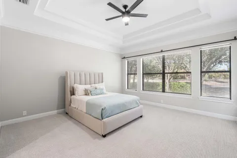 a large white bed sitting in a room next to a window