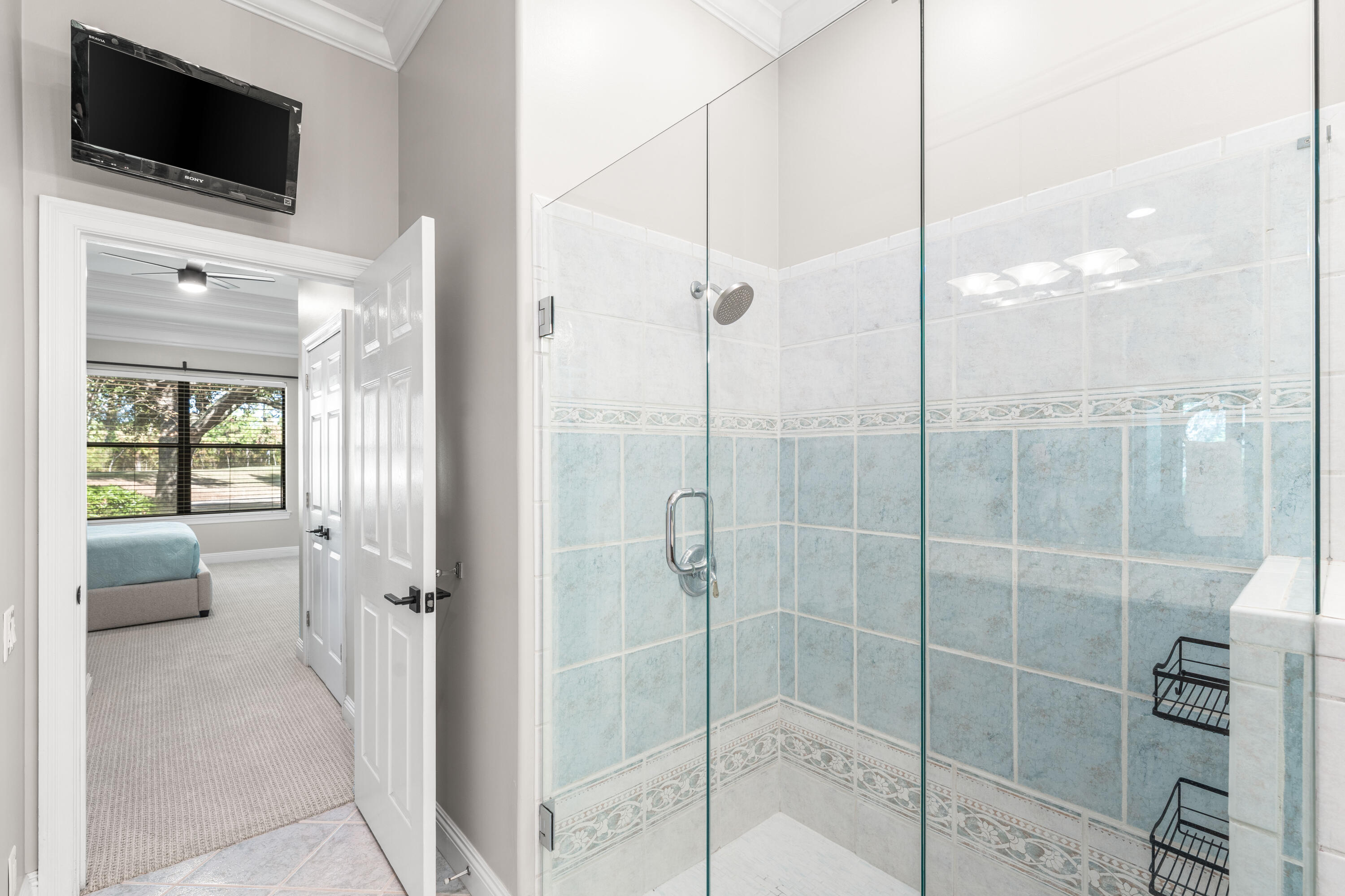 4345 Carriage Lane Destin, FL 32541 - Photo 24 of 39 a bathroom with a shower and a flat screen tv