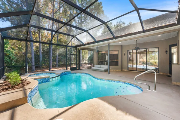 a swimming pool with outdoor seating and yard