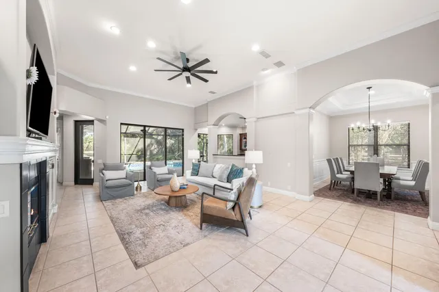 a living room with furniture a fireplace and a flat screen tv