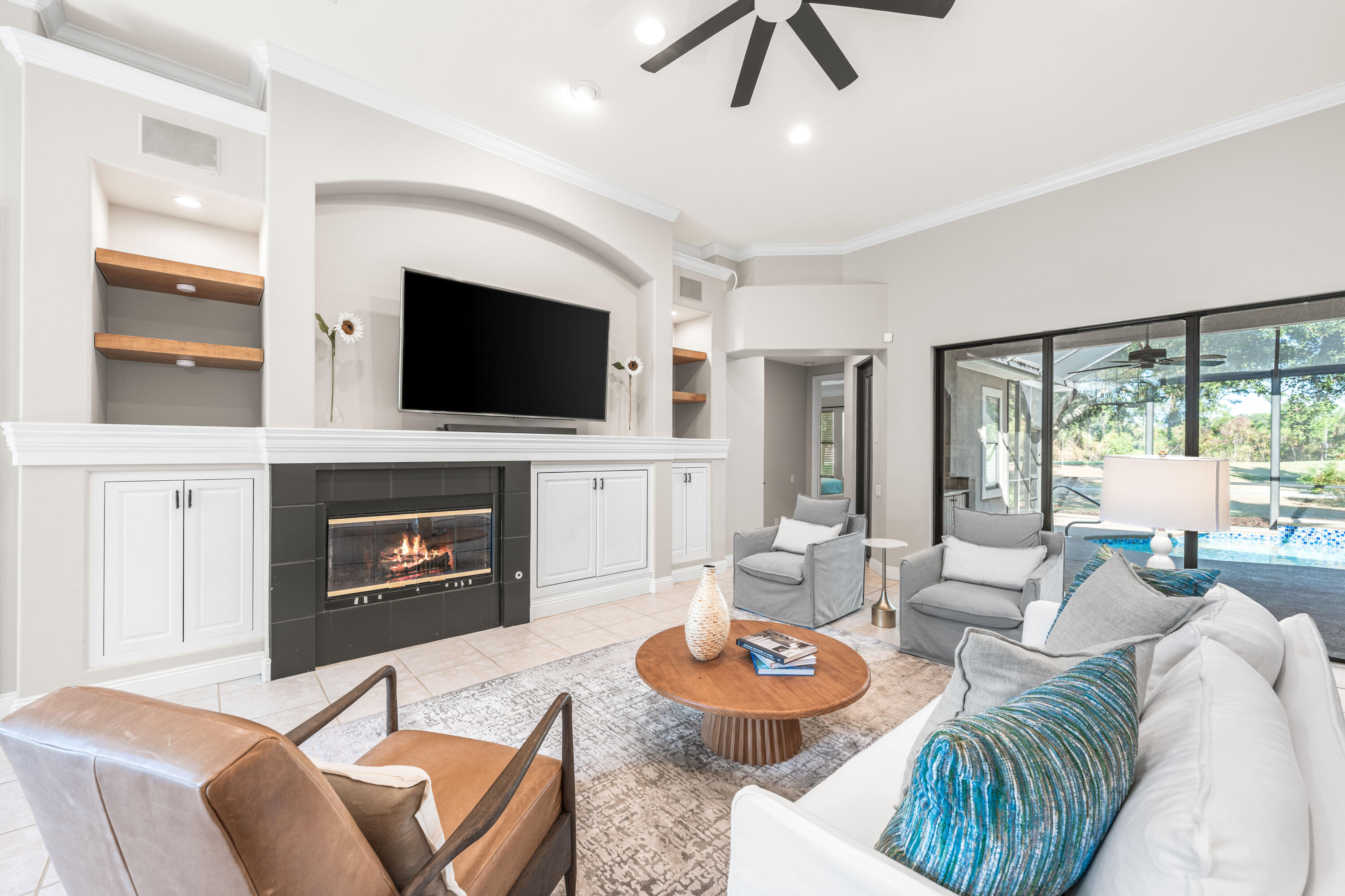 4345 Carriage Lane Destin, FL 32541 - Photo 8 of 39 a living room with furniture a fireplace and a flat screen tv