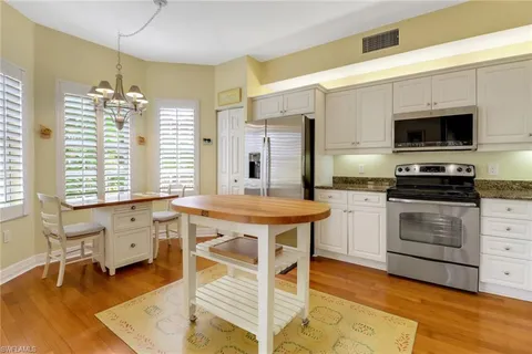 a kitchen with a stove a sink and a refrigerator