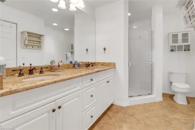 a bathroom with a sink and a mirror with toilet