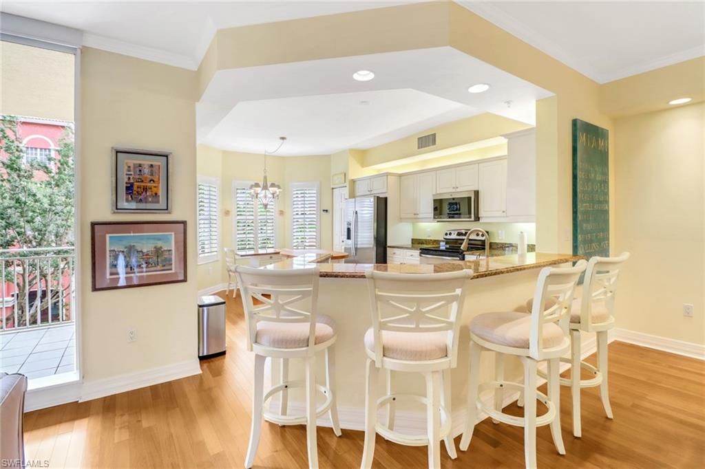 410 Bayfront Place, Unit 2303 Naples, FL 34102 - Photo 7 of 31 a large white kitchen with lots of counter space and furniture