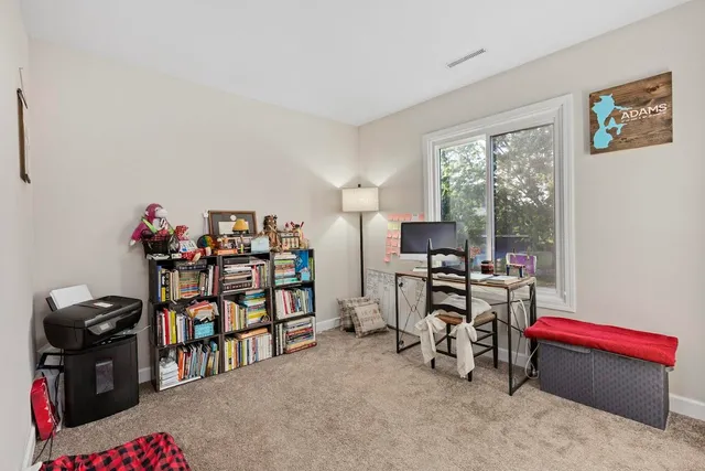 a bedroom with a bed and a wooden floor