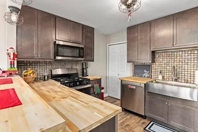 a kitchen with a stove a sink and a microwave