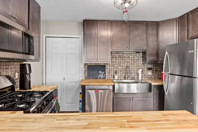 a kitchen with granite countertop stainless steel appliances and wooden cabinets