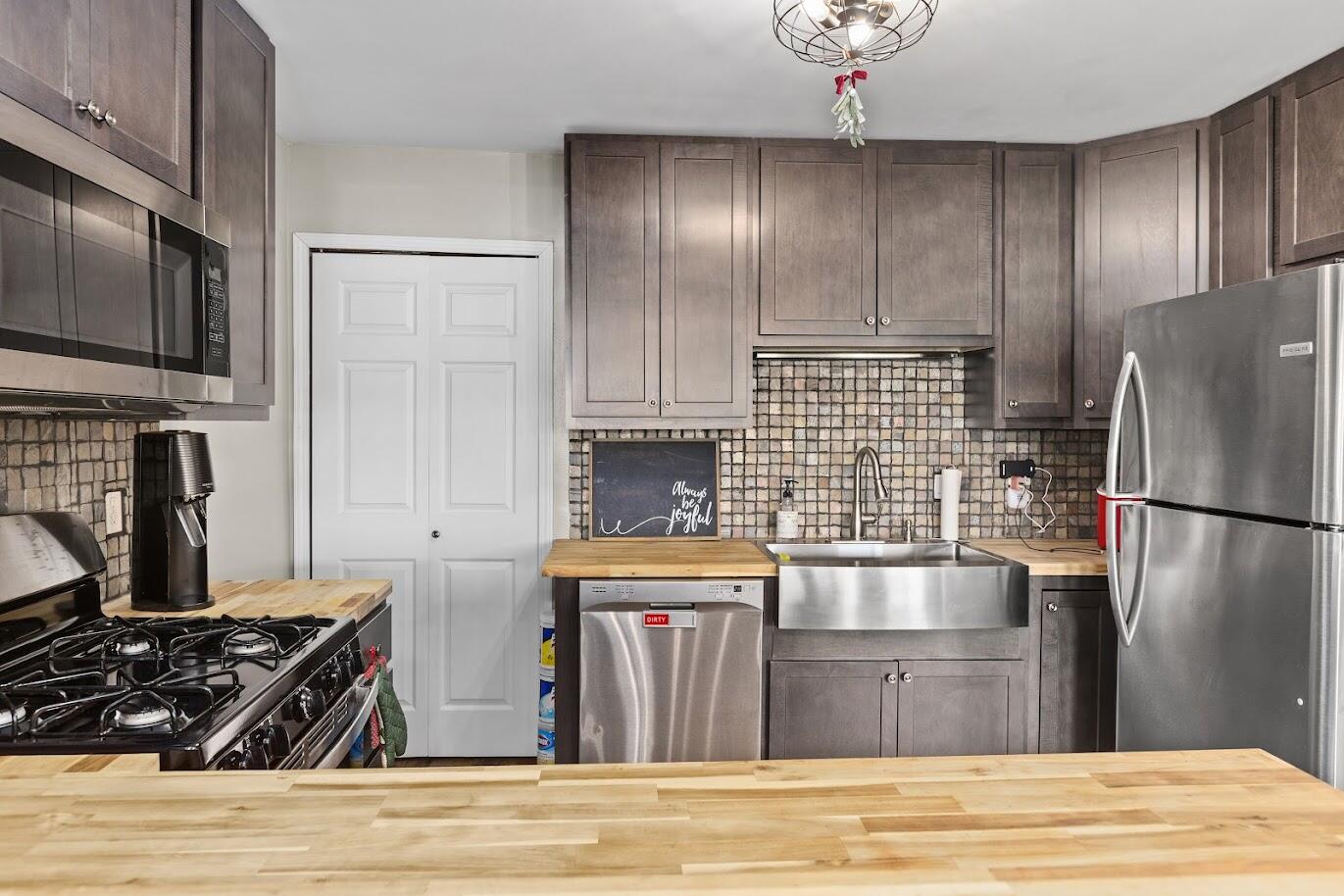 5000 Spinnaker Lane Crown Point, IN 46307 - Photo 9 of 23 a kitchen with granite countertop stainless steel appliances and wooden cabinets