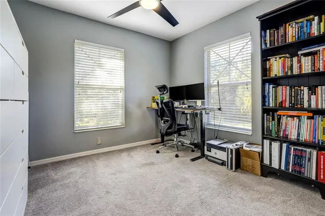 a view of a workspace with furniture and a window