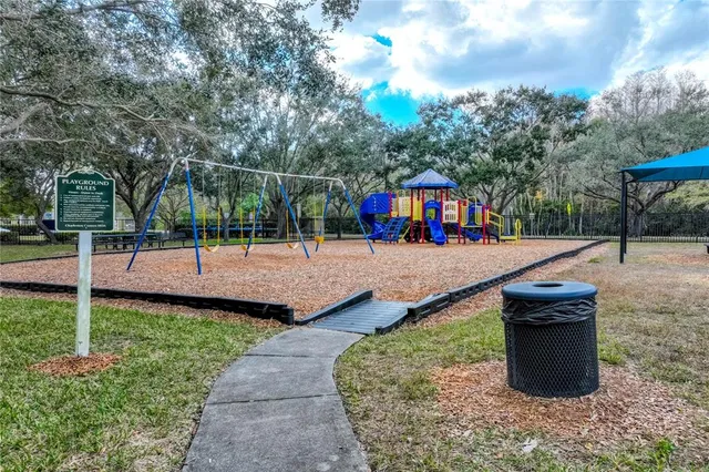 a view of a park with iron fence