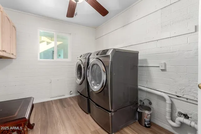 a living room with furniture and a ceiling fan
