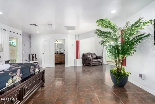 a bedroom with a large bed and a flat screen tv