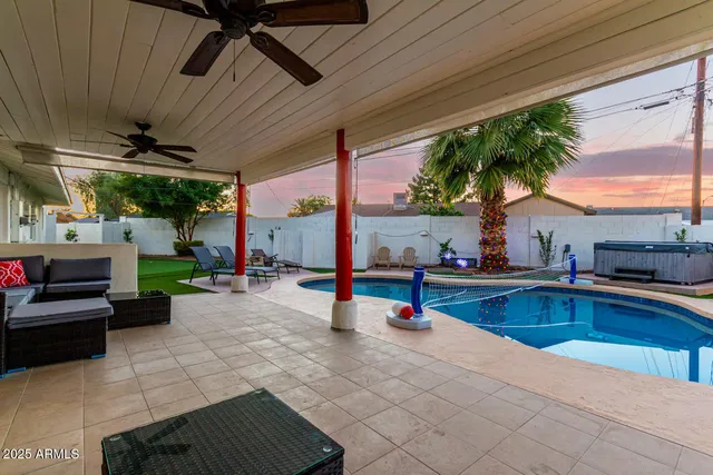 a view of a backyard with swimming pool