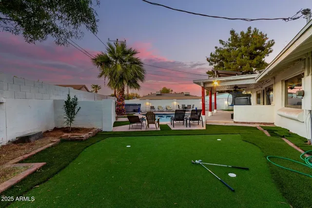 a view of a house with a backyard