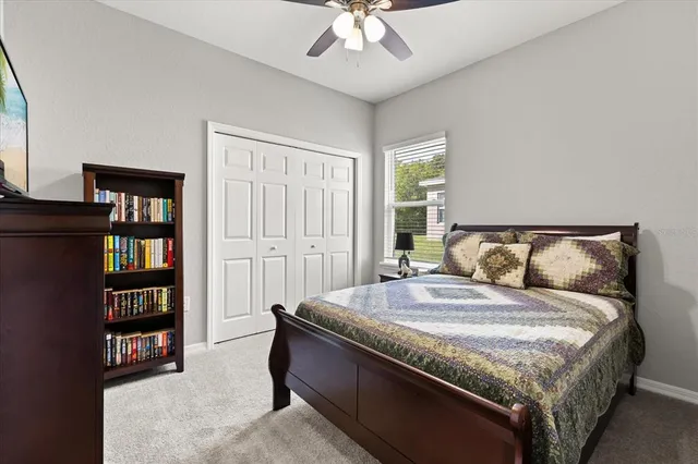 a bedroom with a bed and a book shelf