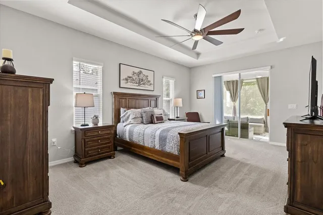 a bedroom with a bed dresser and a flat tv screen