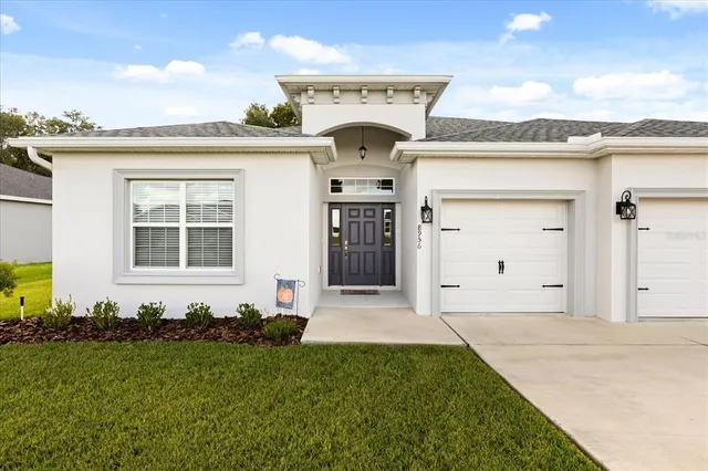 a front view of a house with a garden