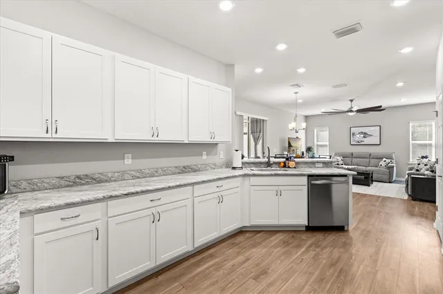 a kitchen with sink and cabinets