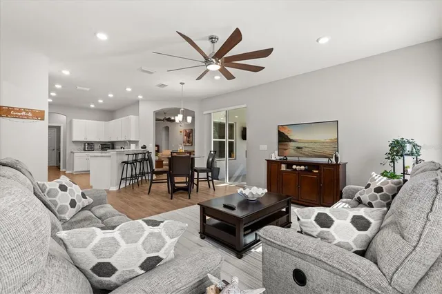 a living room with furniture and view of kitchen