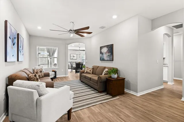 a living room with furniture and a wooden floor