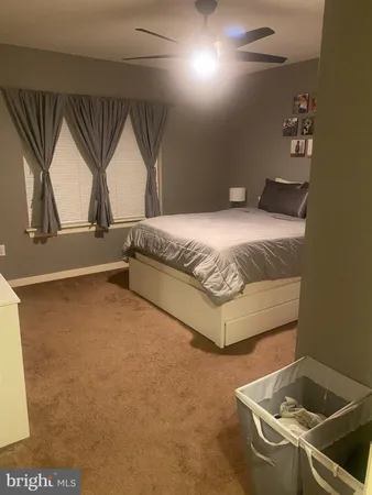 a spacious bedroom with a bed and a cabinets