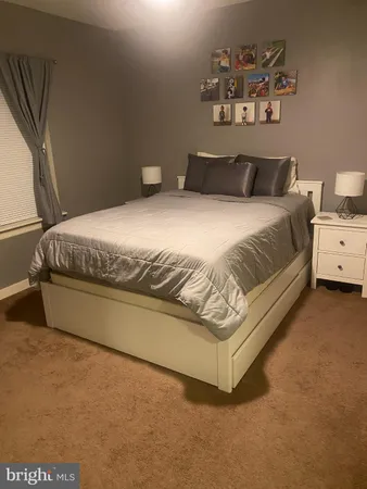 a bedroom with a bed and wall painting