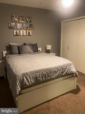 a view of a bedroom with cabinet and mirror