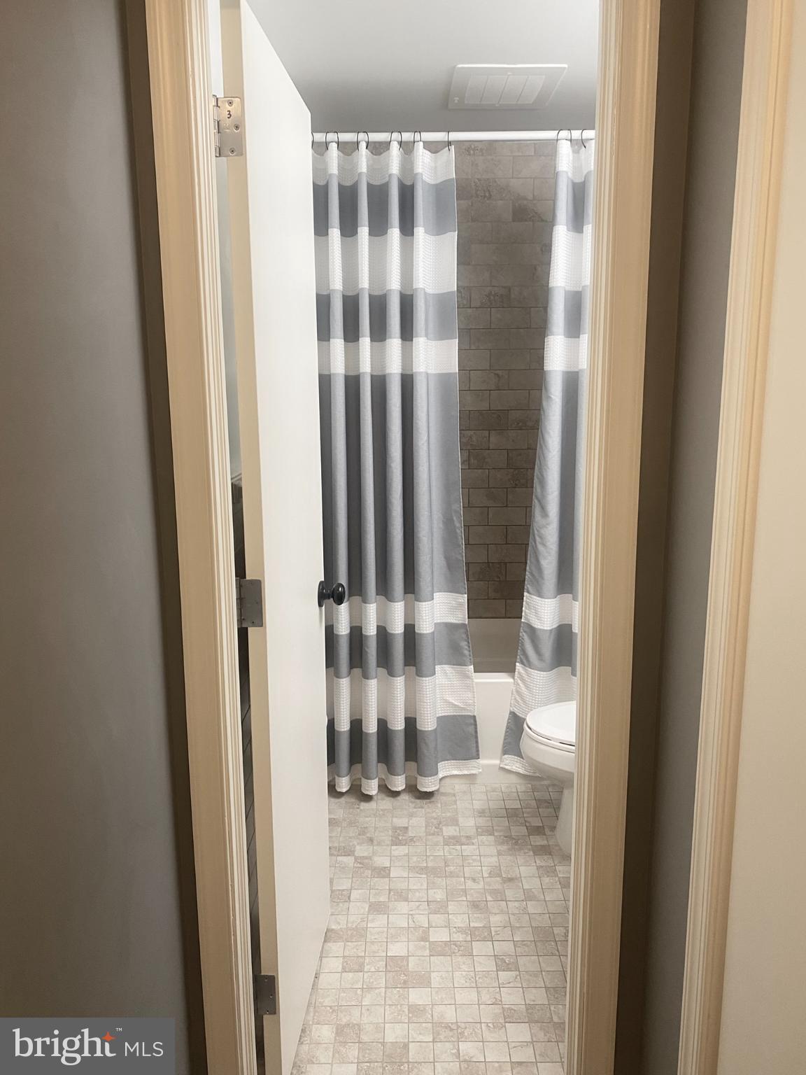 1600 Church Road, Unit B213 Wyncote, PA 19095 - Photo 22 of 25 a view of a bathroom with a shower curtain