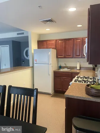 a kitchen with a stove a refrigerator and a sink