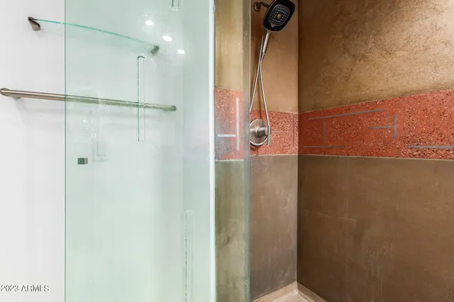 a bathroom with a shower and a mirror