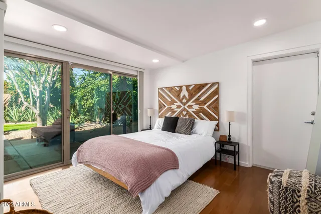 a bedroom with a bed and a floor to ceiling window