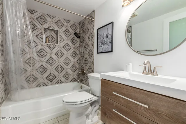 a bathroom with a sink a toilet and a mirror