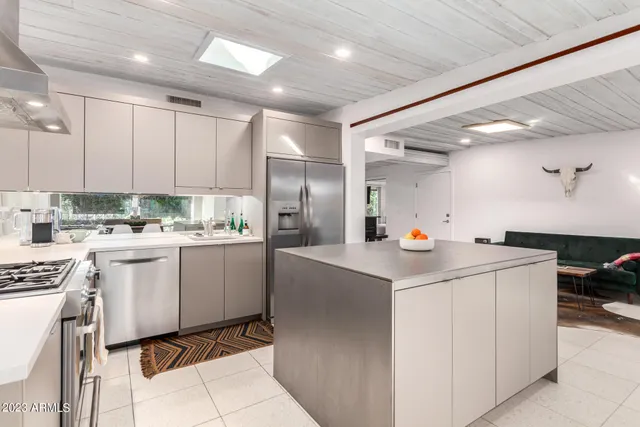 a kitchen with a sink stainless steel appliances and white cabinets